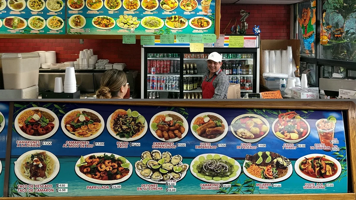 Fresh ceviche beside a chilled drink.