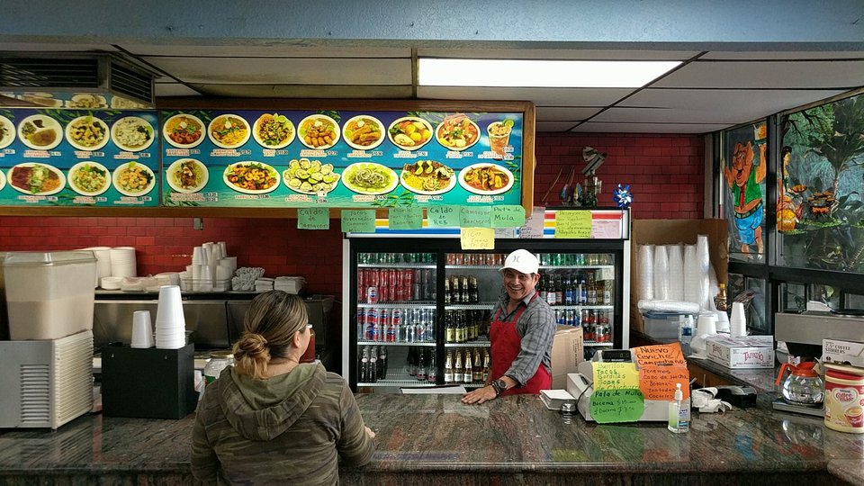 Colorful plates of mariscos and tacos.